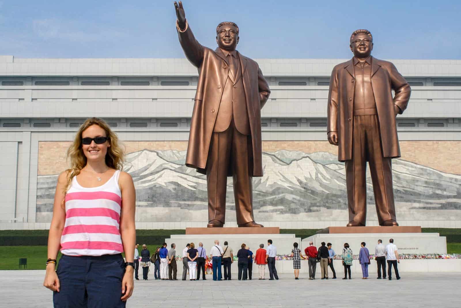 Tourist with Statue of Kim Il Sung and Kim Jong Il in North Korea 