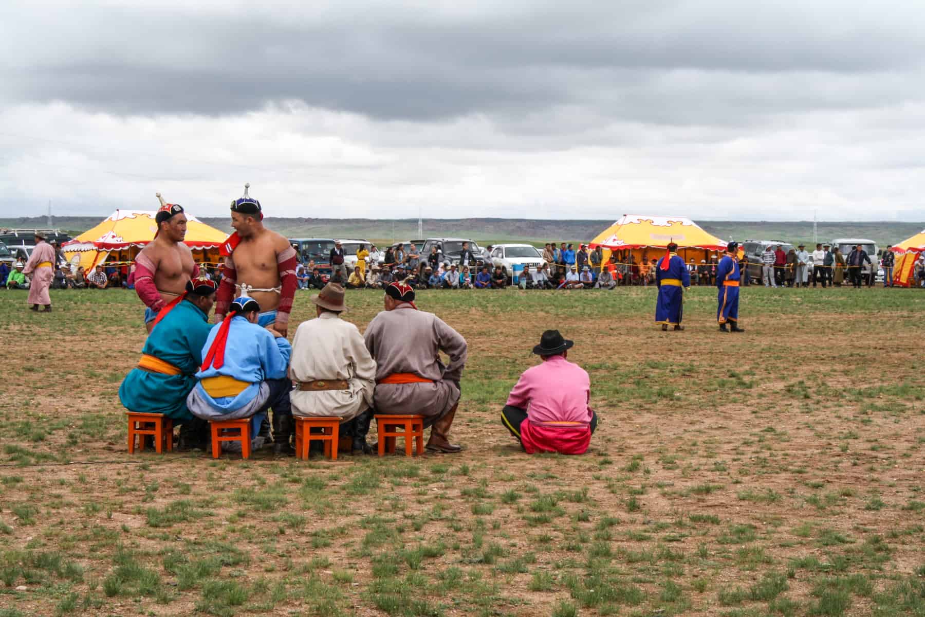 Two wrestlers talks to five judges at the Nadaam Festival in Mongolia