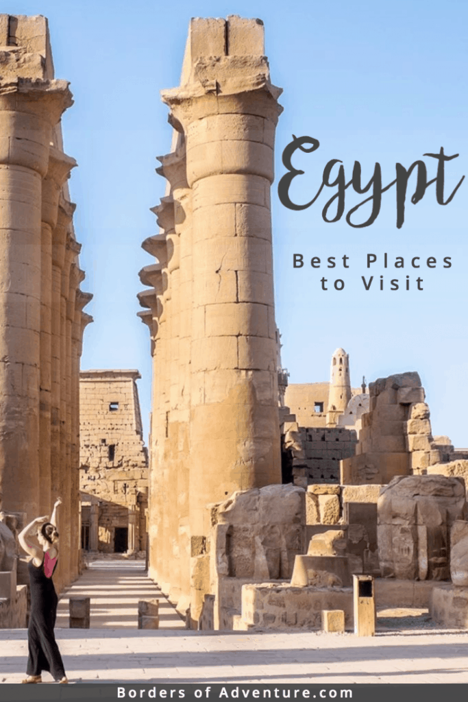 A woman in a black dress dances outside of an Ancient Egyptian Temple complex in Luxor, Egypt