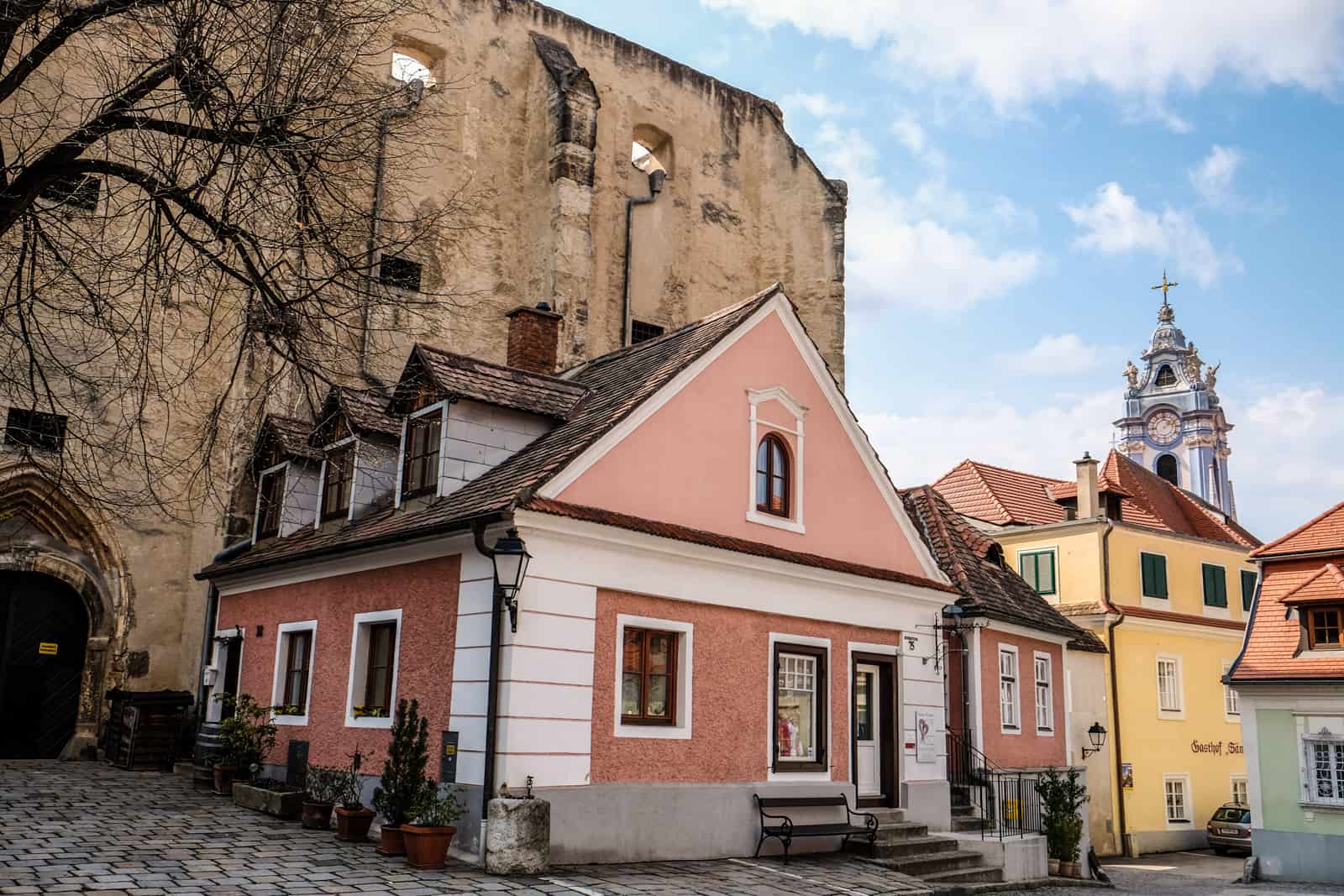 Pink, yellow and mint green buildings with red-roofs in Medieval Drnstein, Austria