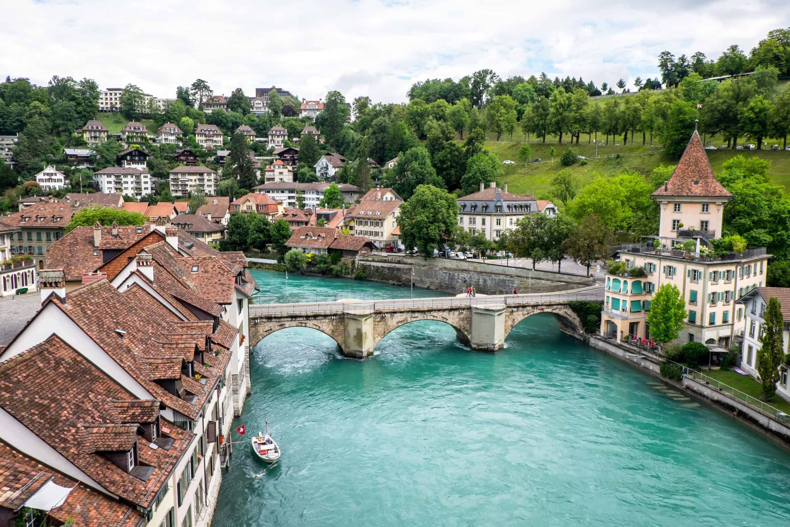 Elevated view of red-roofed Bern Old town and the aqua Aare River flowing through it in Switzerland.