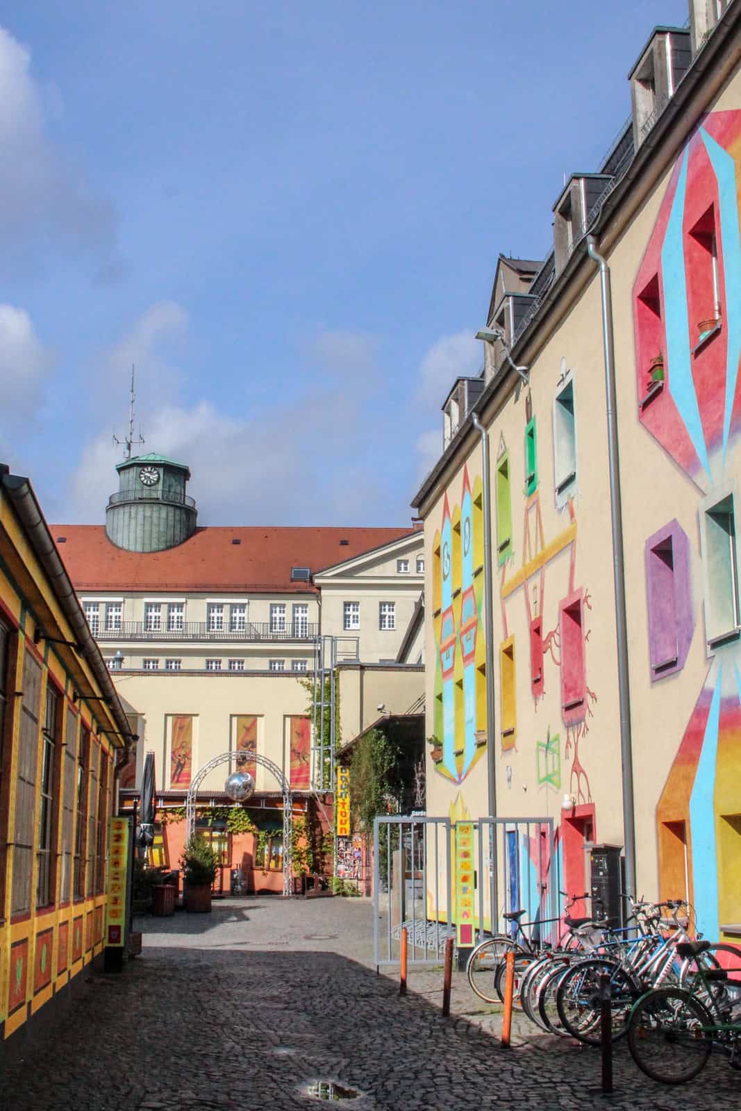 A cobblestone street with painted art houses.