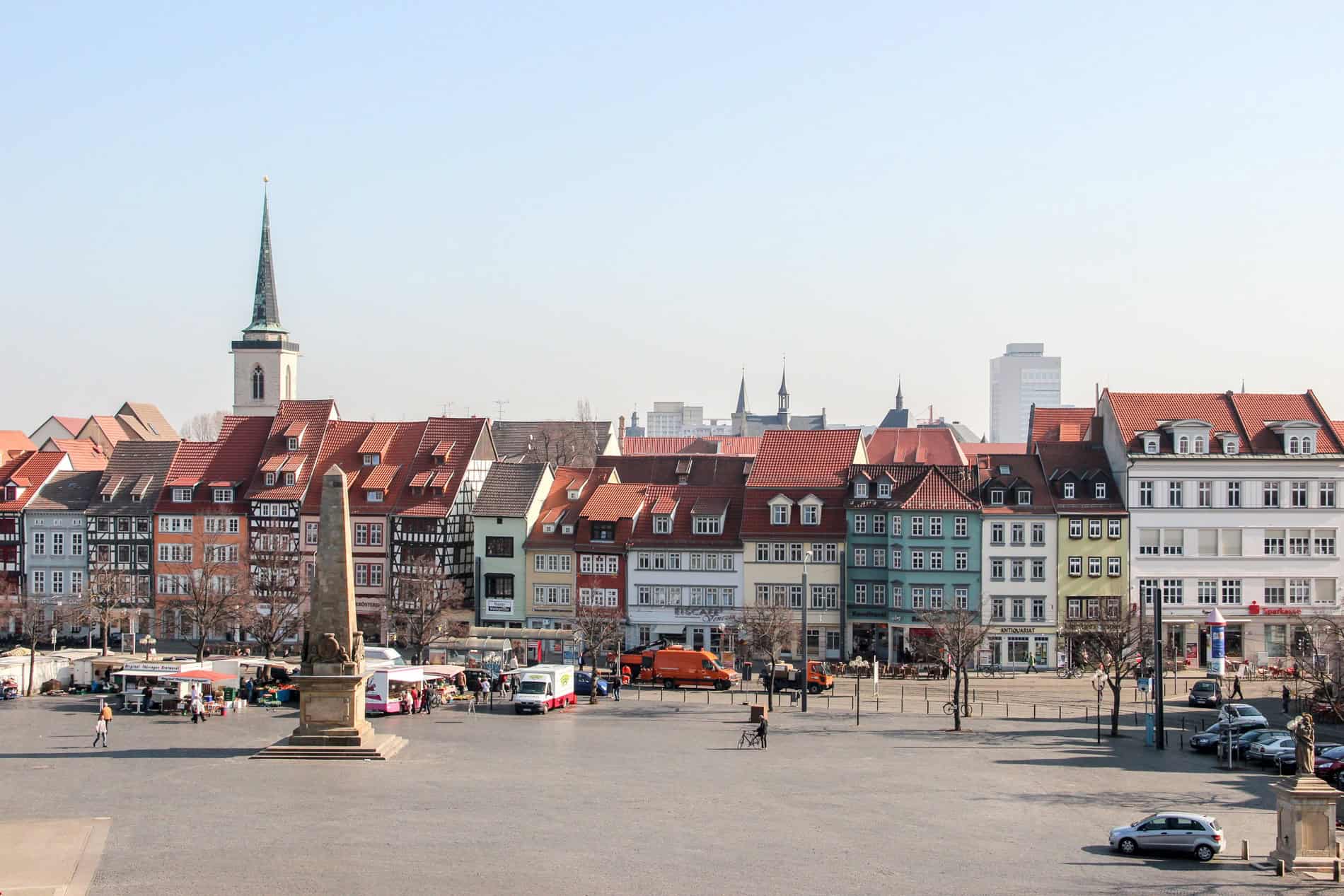 A row of thin, colourful, renaissance houses on a large open square in Erfurt, Germany. 